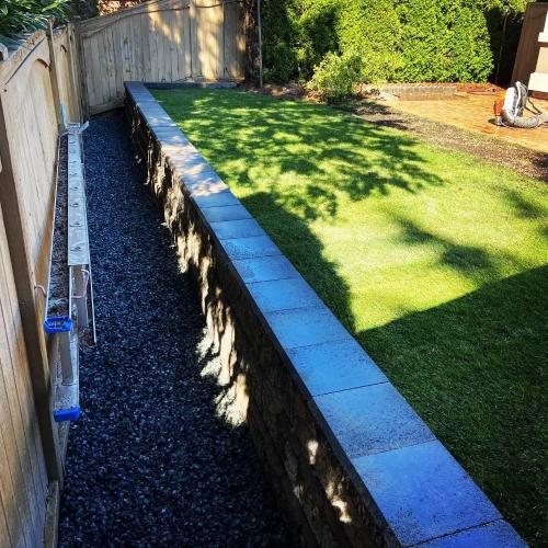  | On this job, a customer of ours wanted to have more usable space, so we removed the cedar hedge and installed a perfect-looking retaining wall that’ll last forever! | Retaining Walls 